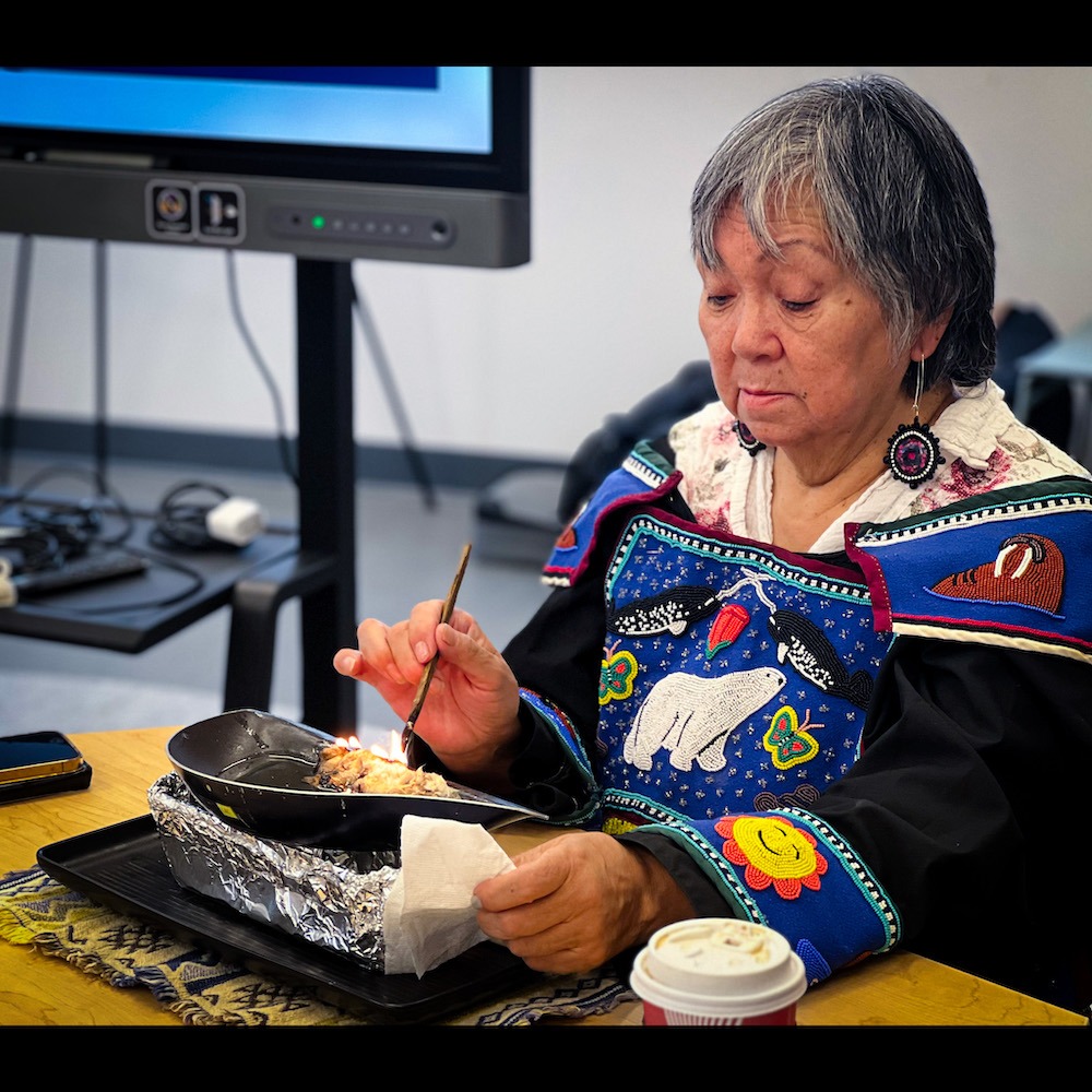 Inuit Elder lighting the Qulliq